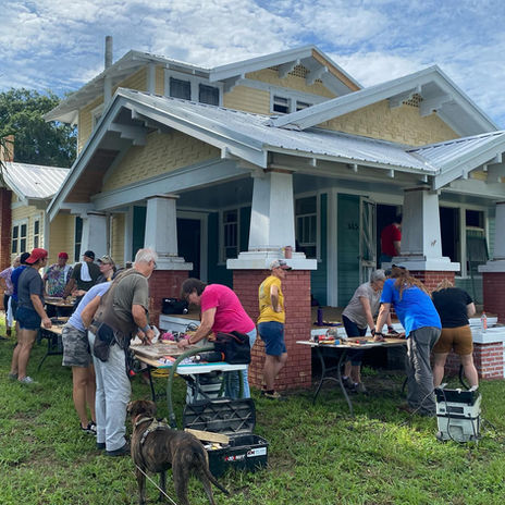 Participants working outside a historic bungalow